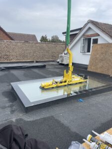 Crane lifting glass with a vacuum glass handler