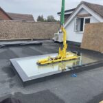 Crane lifting glass with a vacuum glass handler