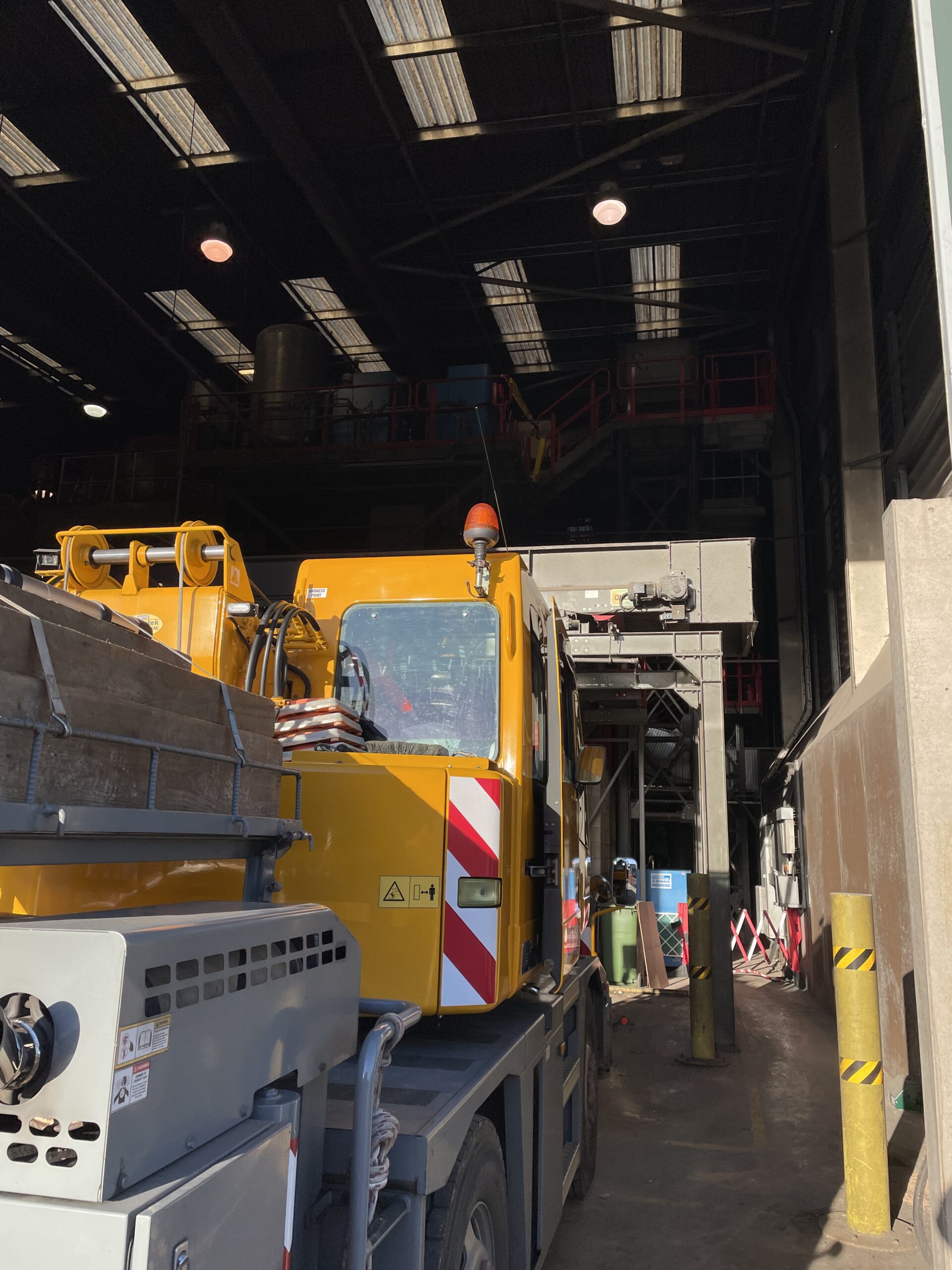 Mobile crane entering an industrial building